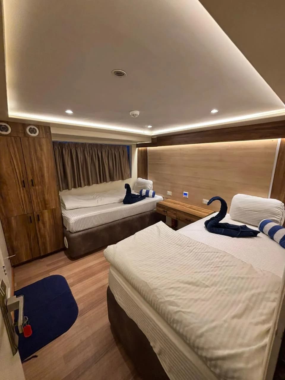 Twin bedded cabin with a sea view window