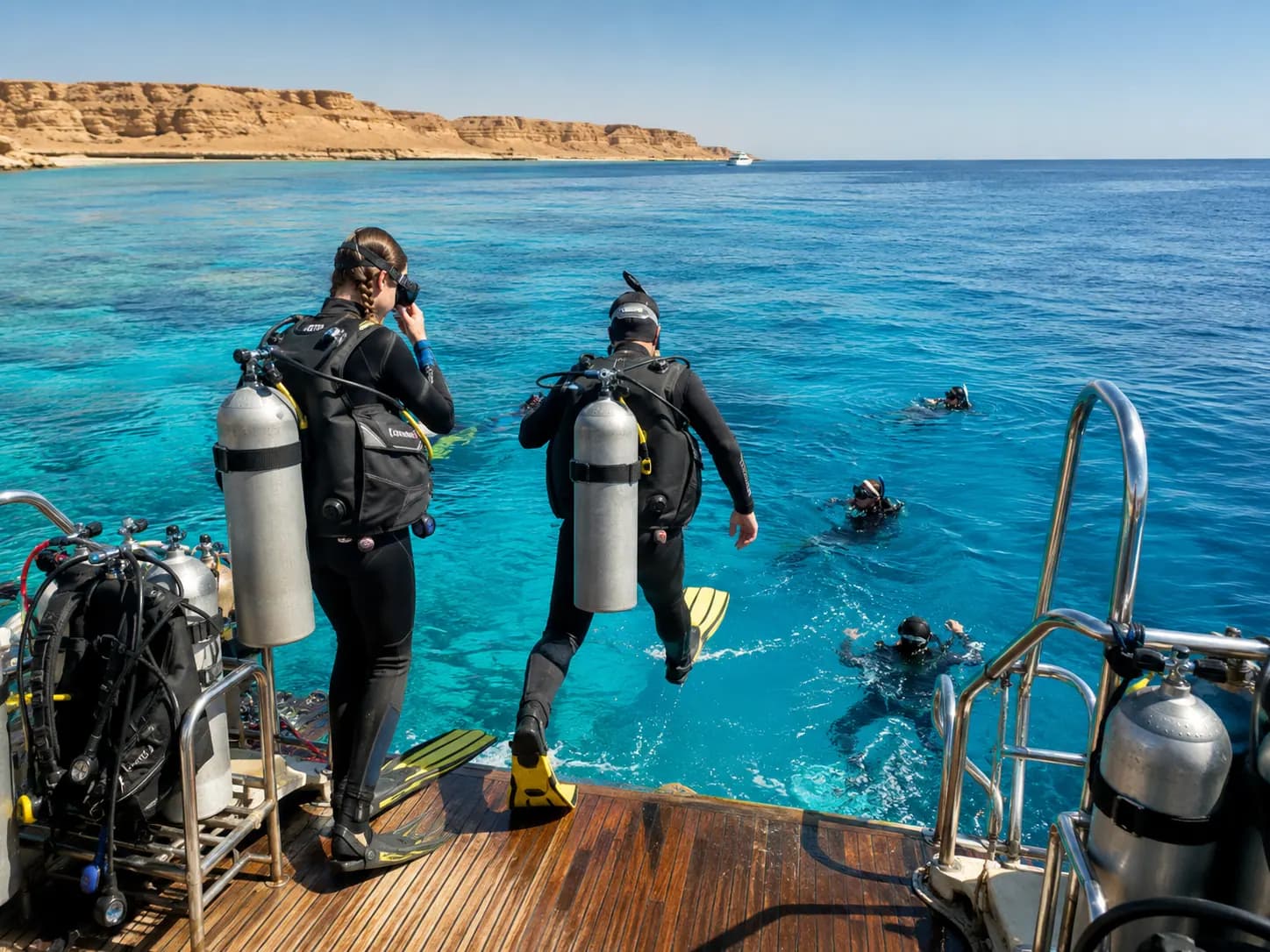 Divers descending along a Red Sea reef